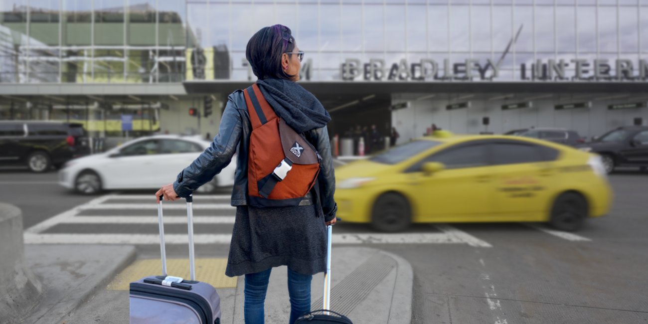 Woman at LAX airport wearing a X-over crossbody backpack